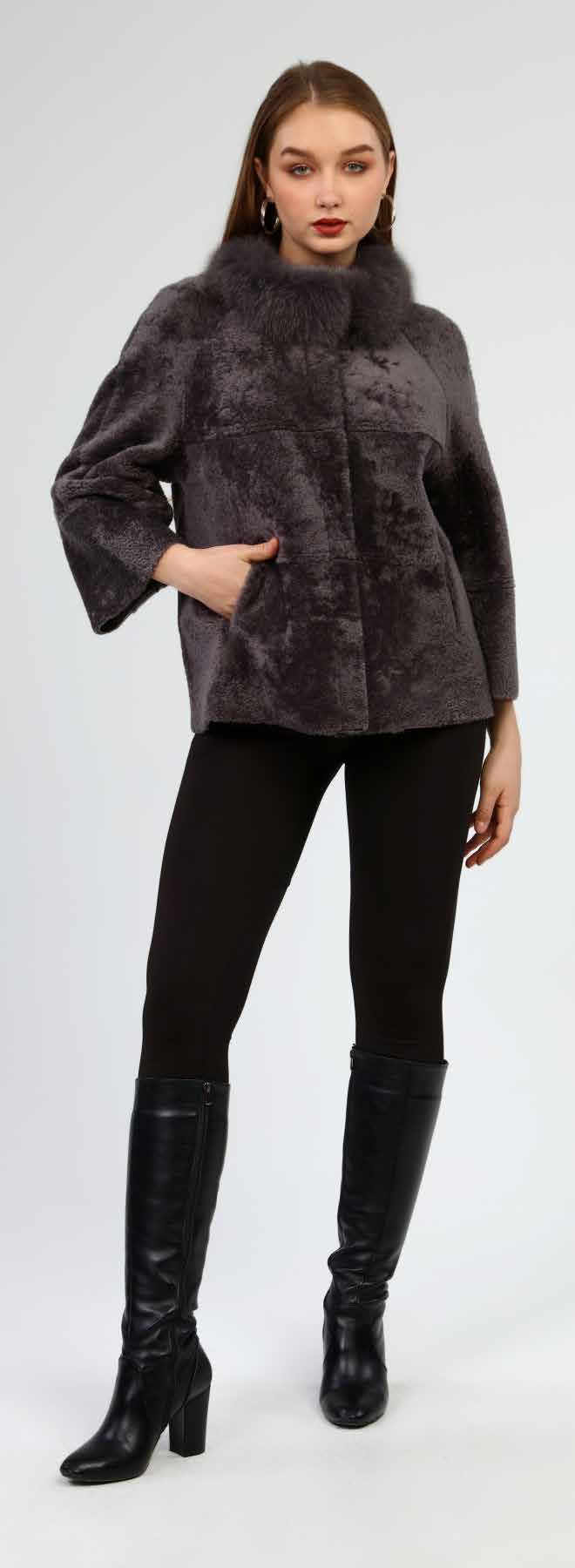 Woman wearing a dark gray fur coat, black leggings, and black knee-high boots on a white background