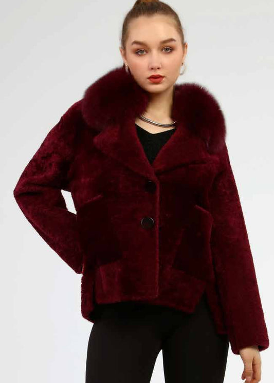 Woman wearing a burgundy coat with fur collar on a white background