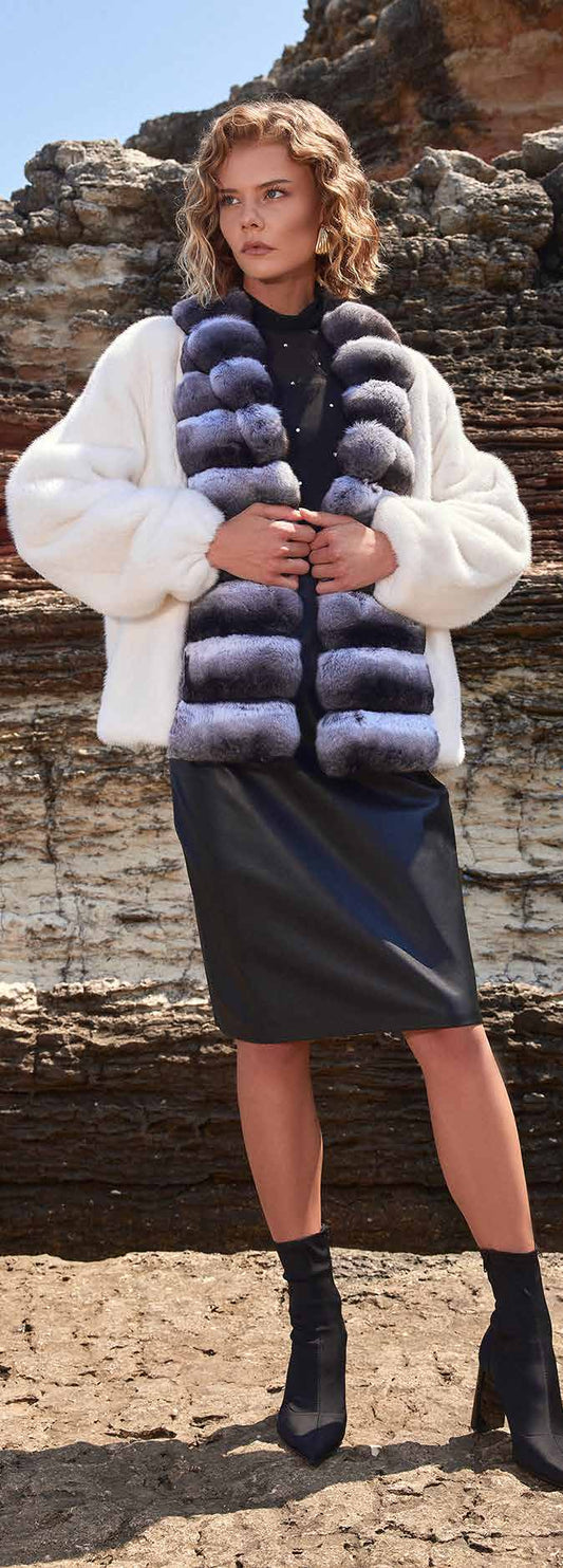 Woman wearing a fur vest with a natural stone background