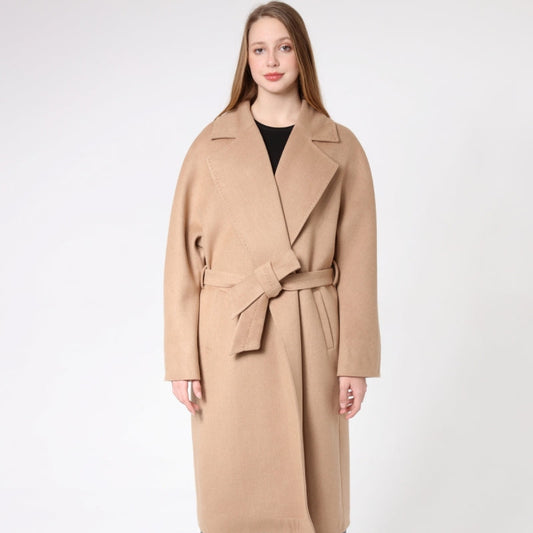 Woman wearing a beige cashmere coat on a white background