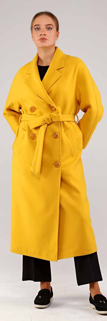 Woman wearing a yellow coat on a white background