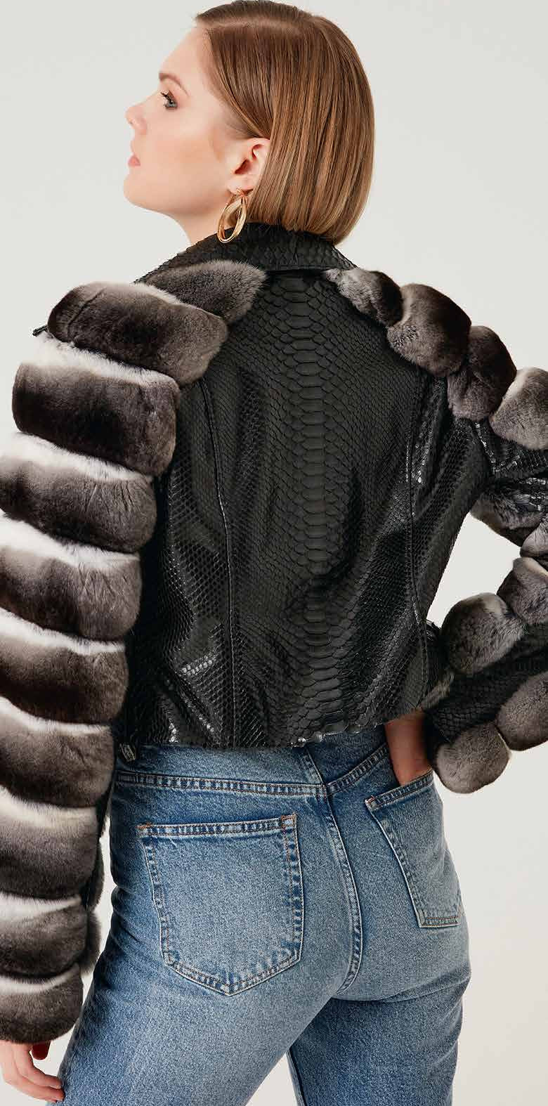 Person wearing a black phyton jacket with unique back chinchilla design on a plain background