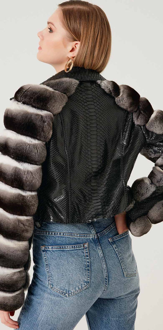 Person wearing a black phyton jacket with unique back chinchilla design on a plain background