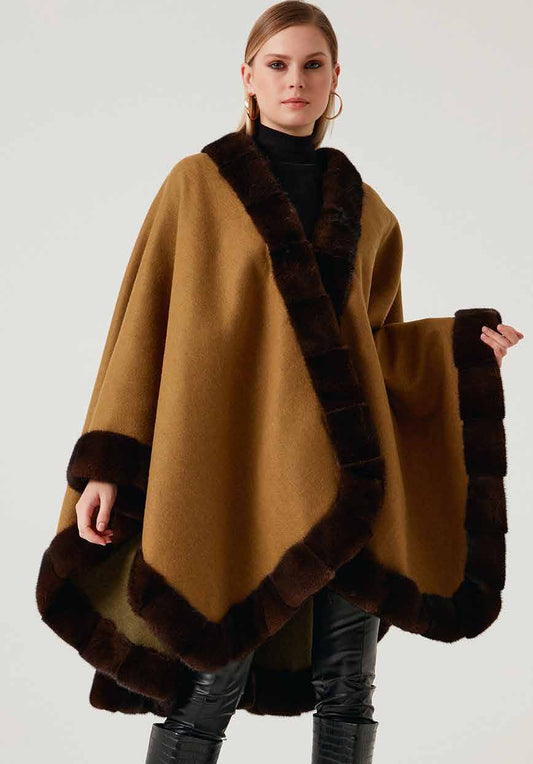 Woman wearing a brown shawl with mink fur on a white background