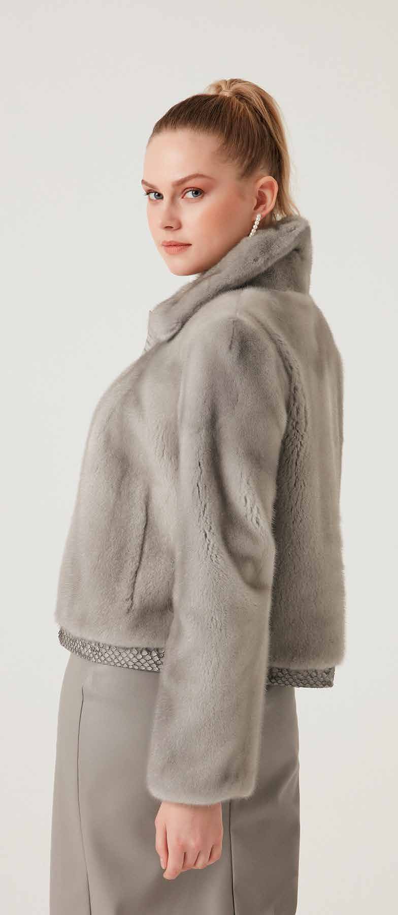 Woman wearing a gray fleece jacket on a white background