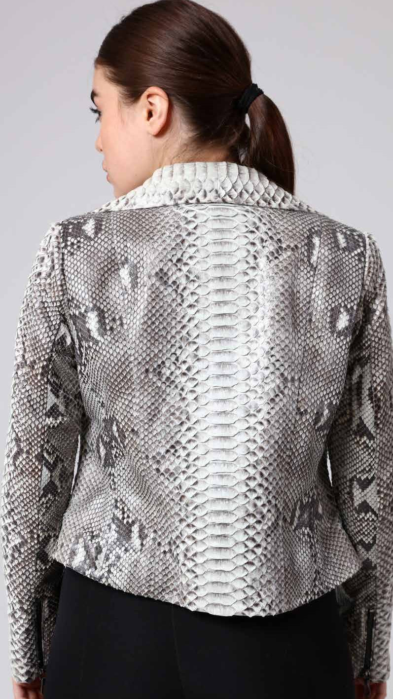 Woman wearing a phyton jacket on a plain background