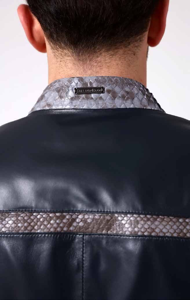 Close-up of a person wearing a black leather jacket with a patterned collar and visible brand label.