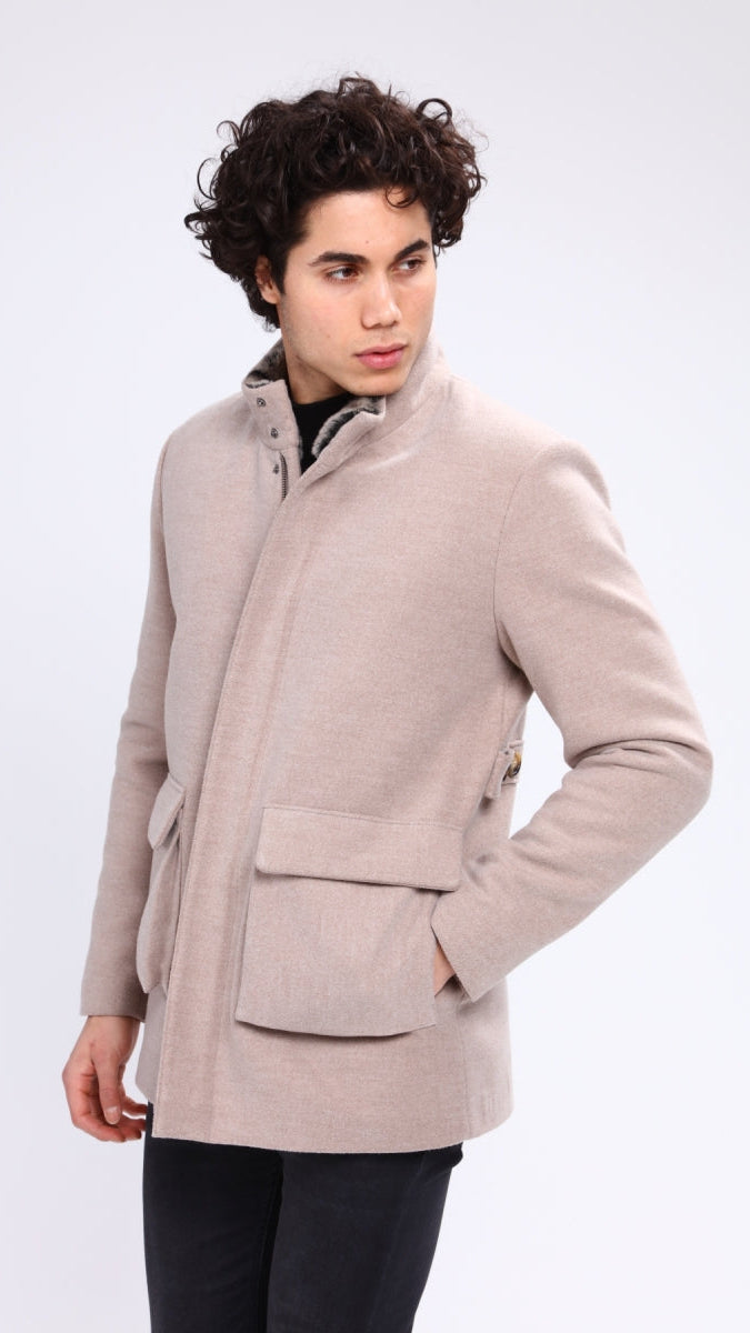 Man wearing a beige coat on a white background