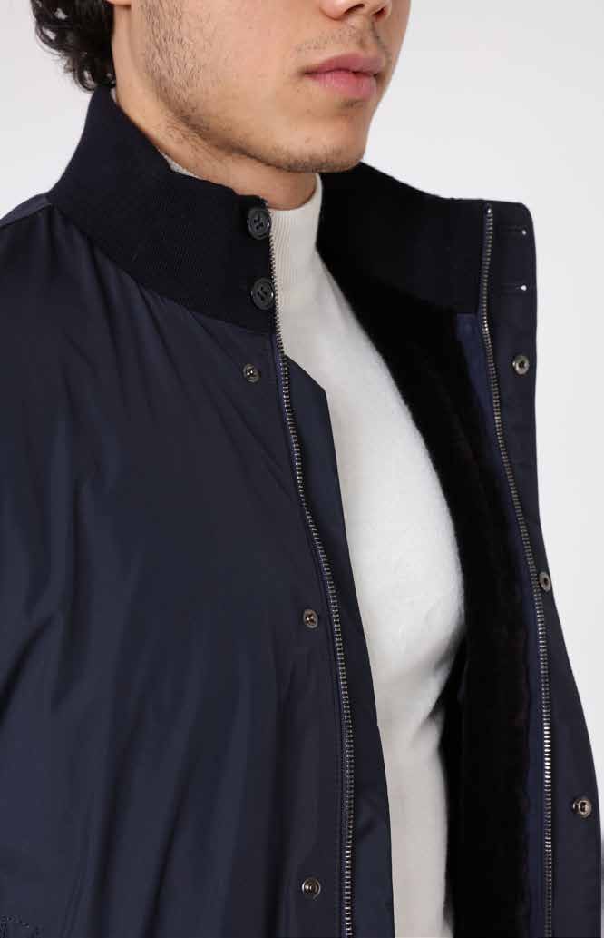Navy blue jacket with a white shirt underneath on a plain background