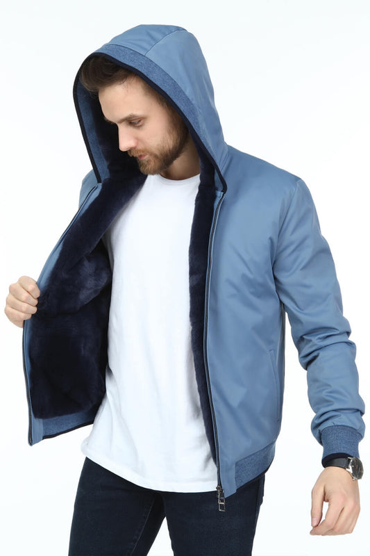 Man wearing a blue hoodie with a white shirt underneath on a white background