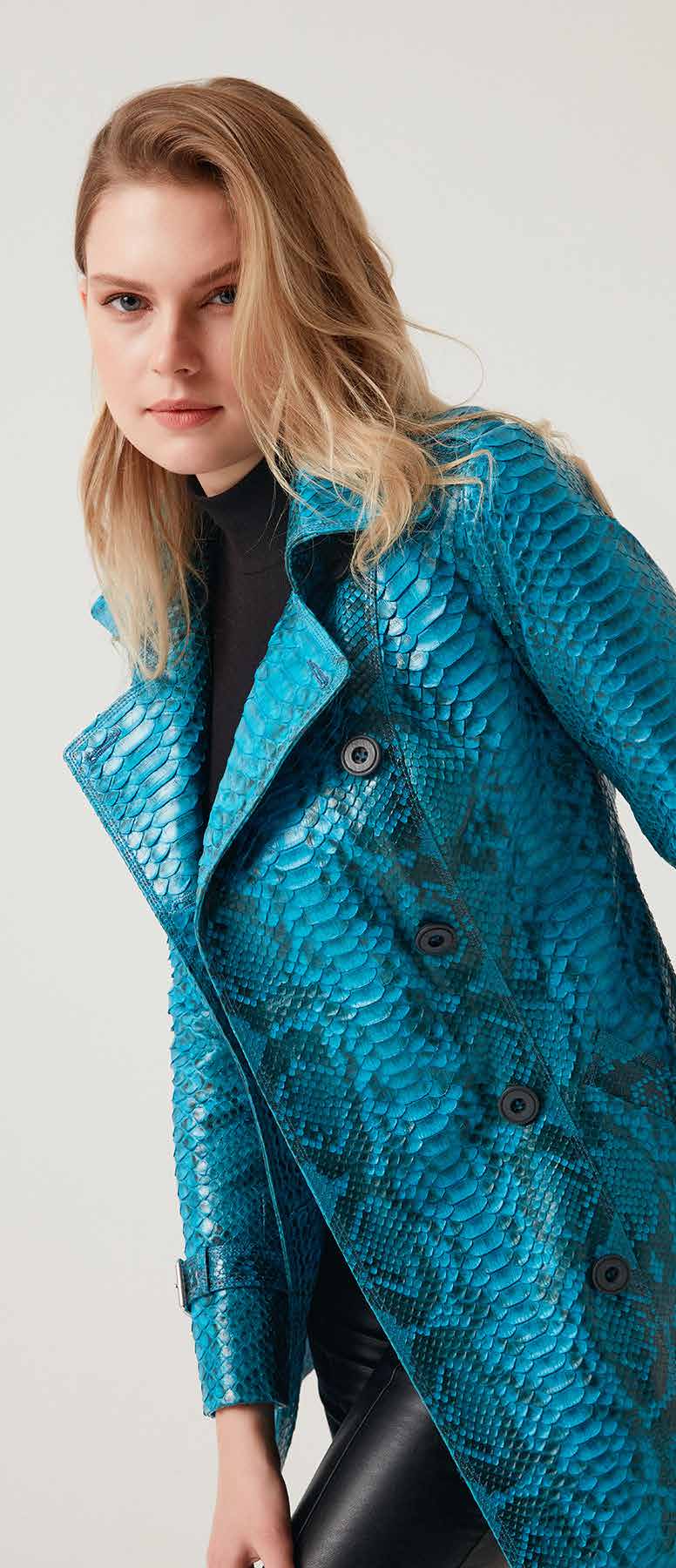 Woman wearing a blue phyton jacket on a white background