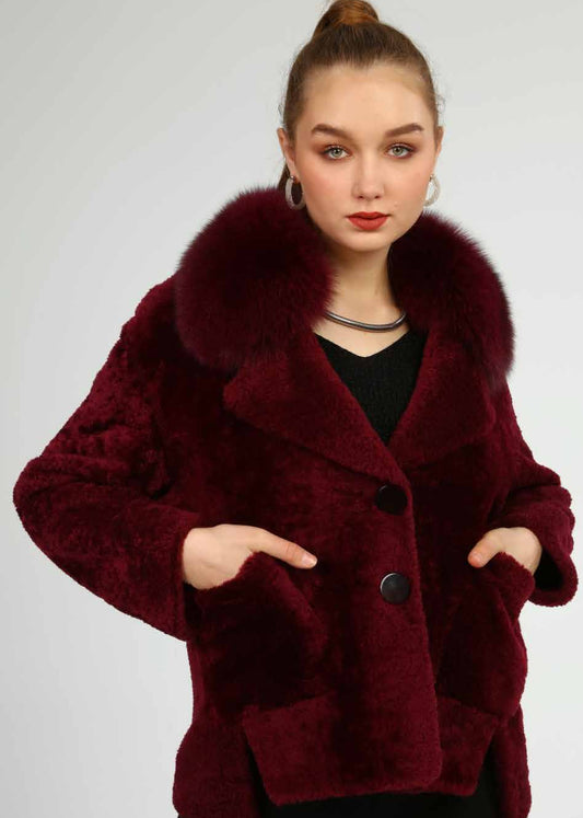 Woman wearing a burgundy fur coat with a white background