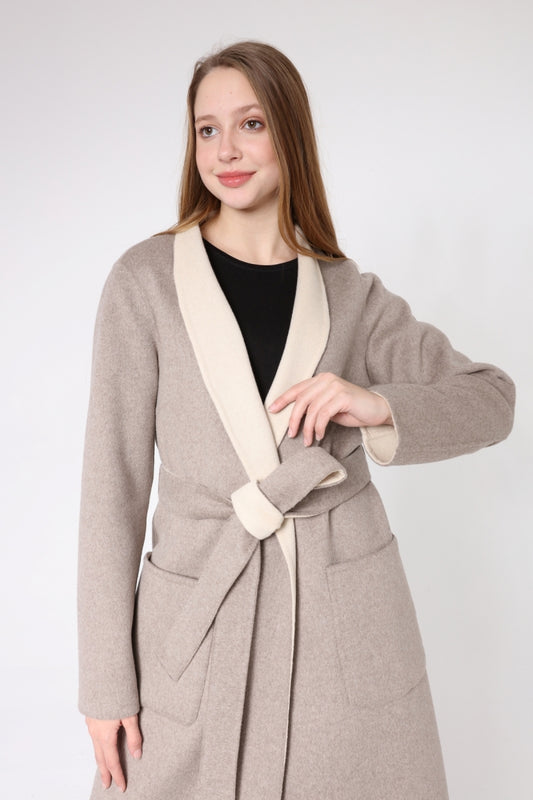 Woman wearing a beige coat with a white collar on a white background