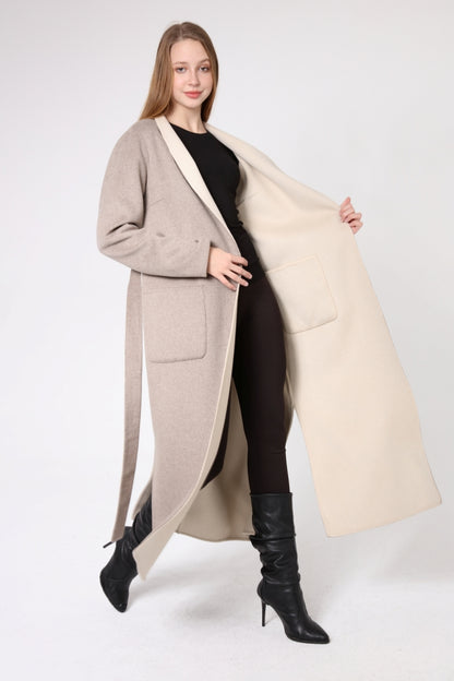 Woman wearing a long beige coat with a cream-colored lining on a white background