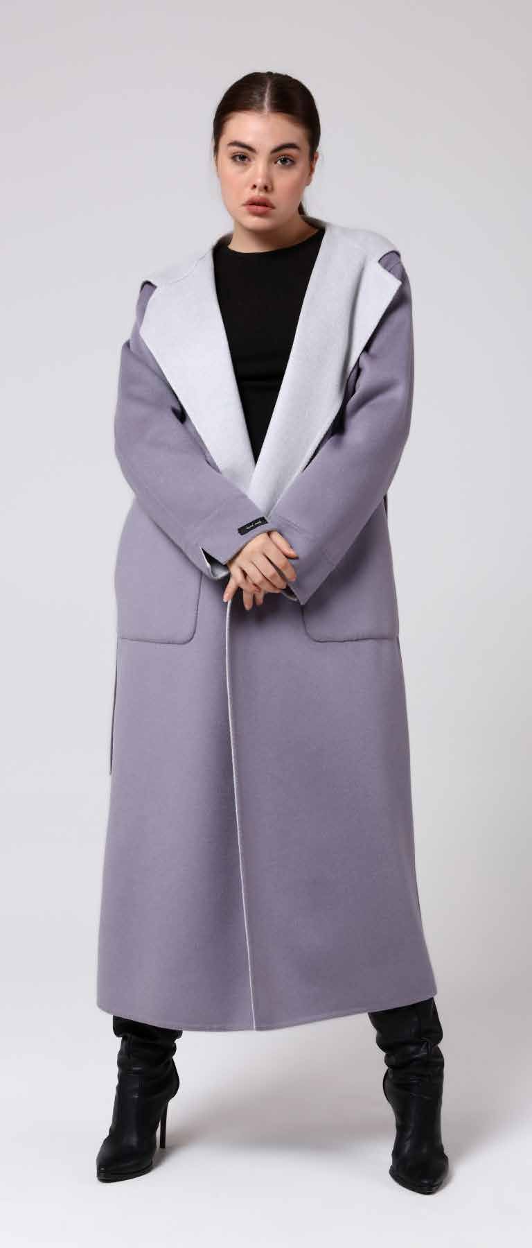 Woman wearing a long gray coat with a white hood on a white background