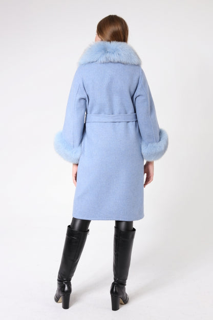 Light blue coat with fur collar worn by a person on a white background