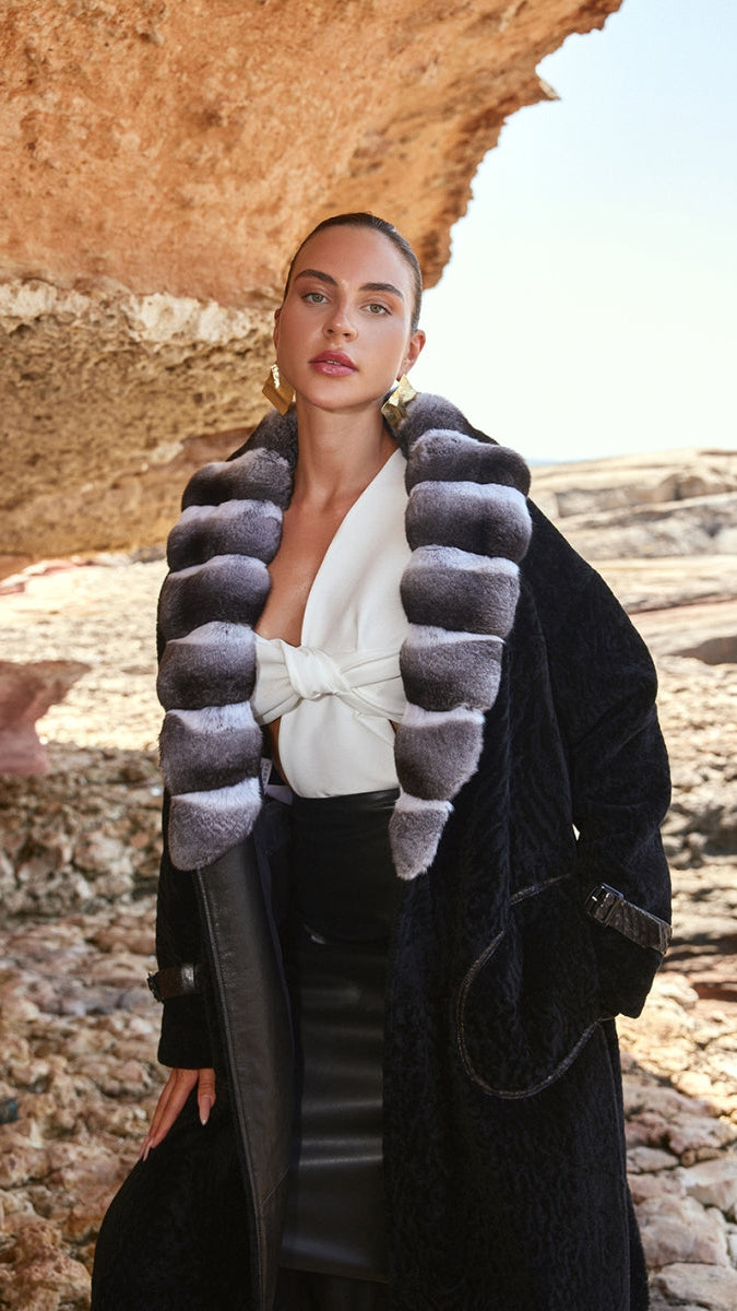 Woman wearing a stylish coat with a textured collar in a desert setting