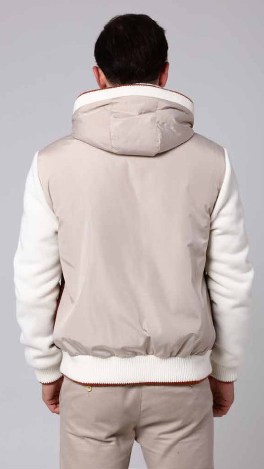 Woman wearing a beige and white jacket on a gray background