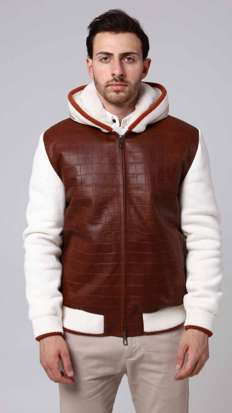 Man wearing a brown and white leather jacket on a gray background