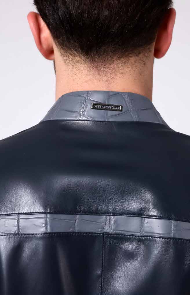 Back view of a person wearing a black leather jacket with a visible brand label.