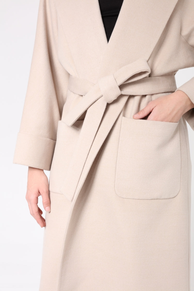 Beige coat with a belt on a white background