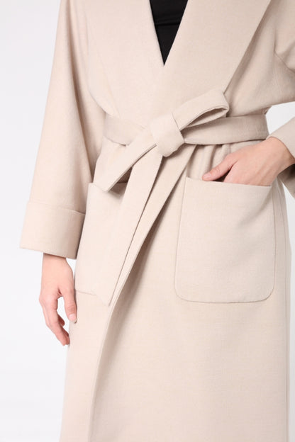 Beige coat with a belt on a white background