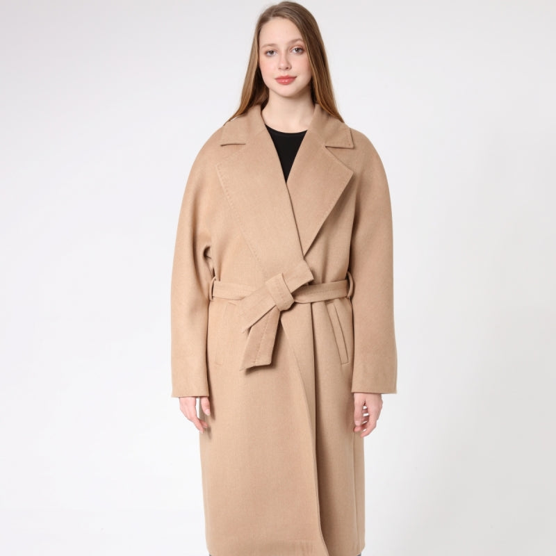 Woman wearing a beige cashmere coat on a white background