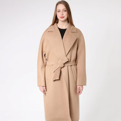 Woman wearing a beige cashmere coat on a white background