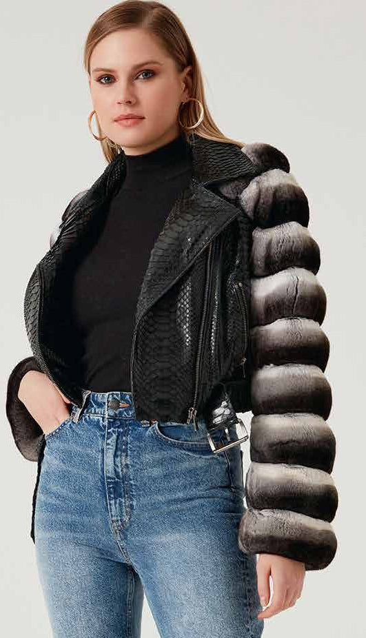 Woman wearing a black phyton jacket, black chinchilla, and blue jeans on a white background