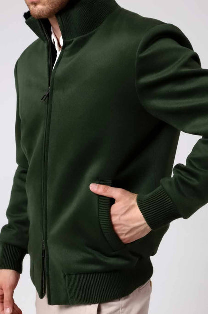 Woman wearing a green jacket with a white background