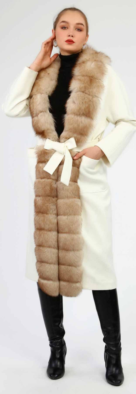 Woman wearing a long fox fur  cashmere overcoat on a white background