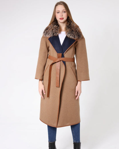 Woman wearing a long brown coat with fur collar on a white background