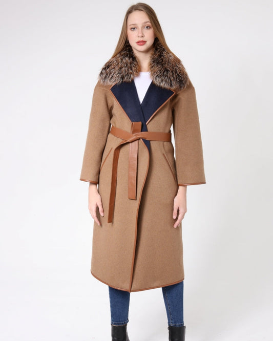 Woman wearing a long brown coat with fur collar on a white background