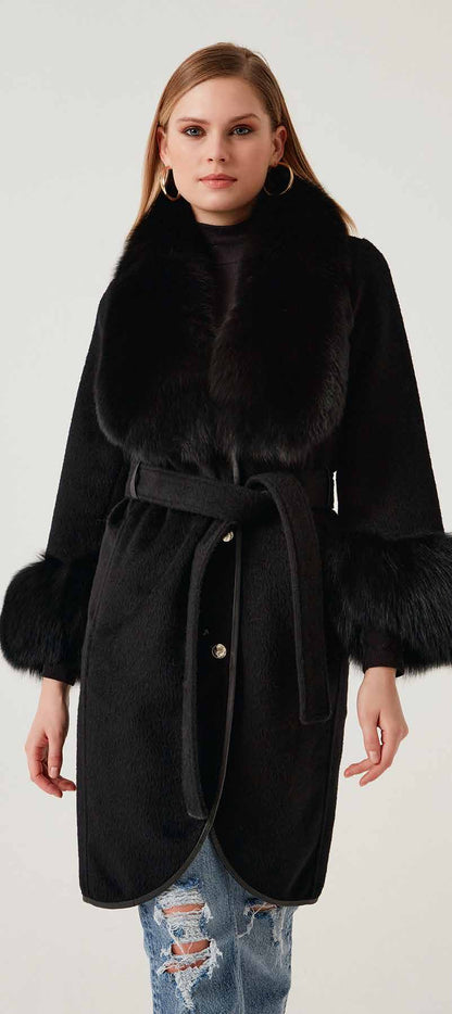 Woman wearing a black coat with fur trim on a white background