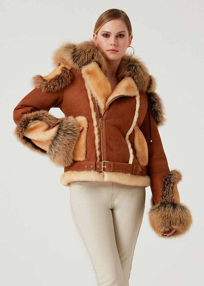 Woman wearing a brown shearling jacket with fur trim on a white background