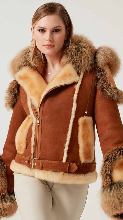 Woman wearing a brown shearling jacket with fur trim on a white background