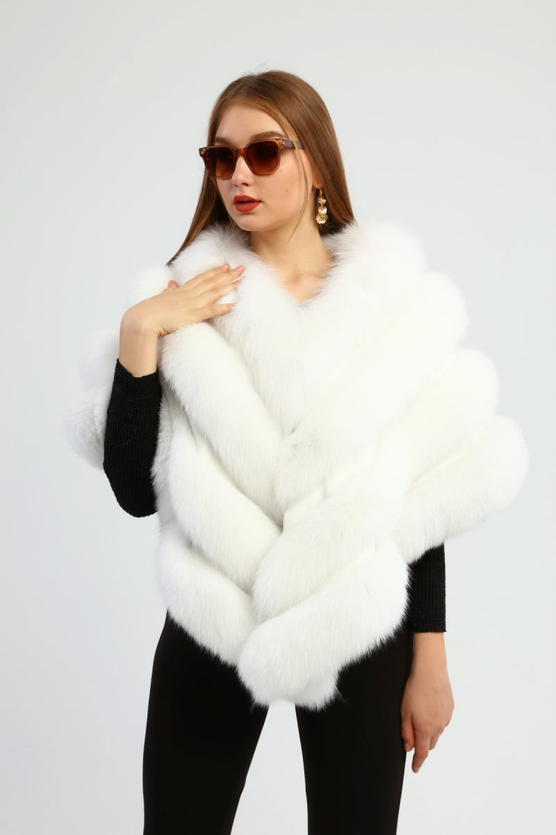 Woman wearing a white fox fur shawl against a white background
