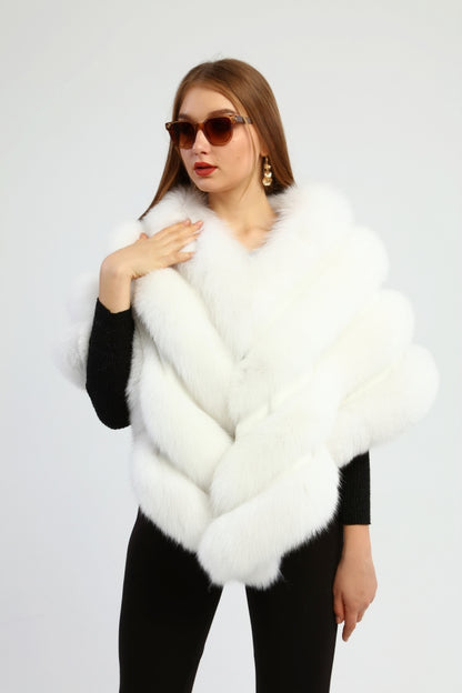 Woman wearing a white fox fur shawl against a white background