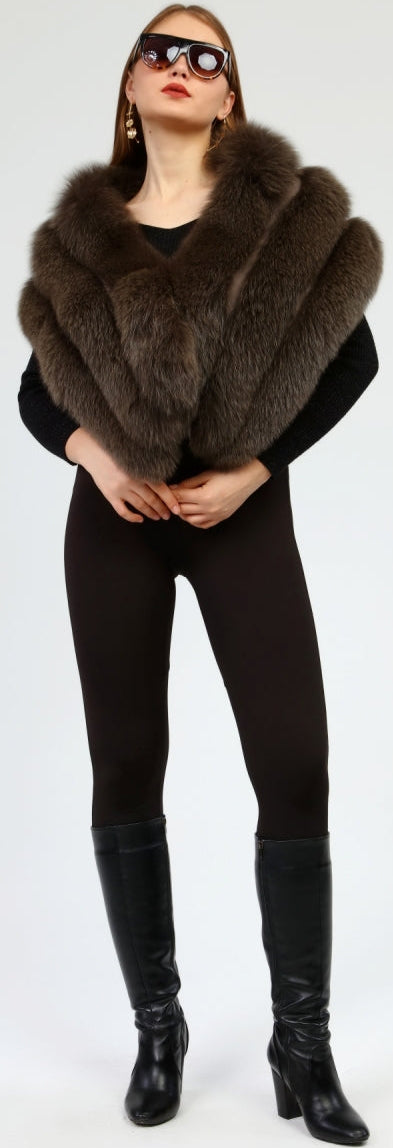Woman wearing a brown fox fur shawl over a black outfit on a white background