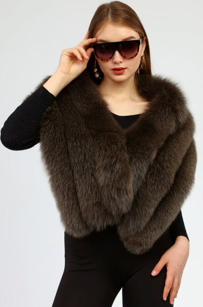 Woman wearing a brown fox fur shawl and sunglasses on a white background
