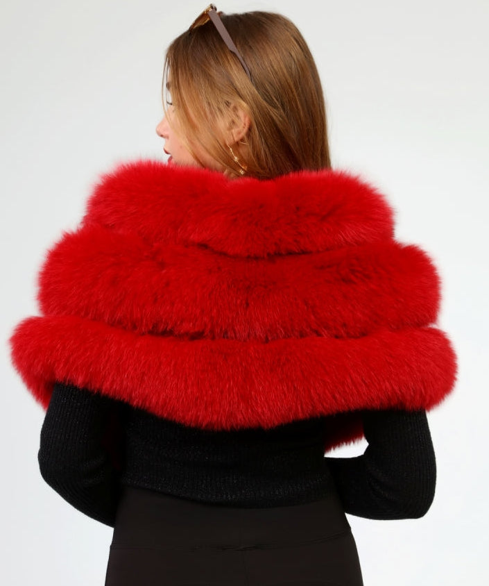 Person wearing a red fox fur shawl on a white background