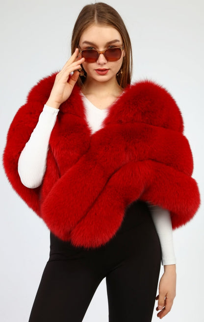 Woman wearing a red fox fur shawl on a light gray background