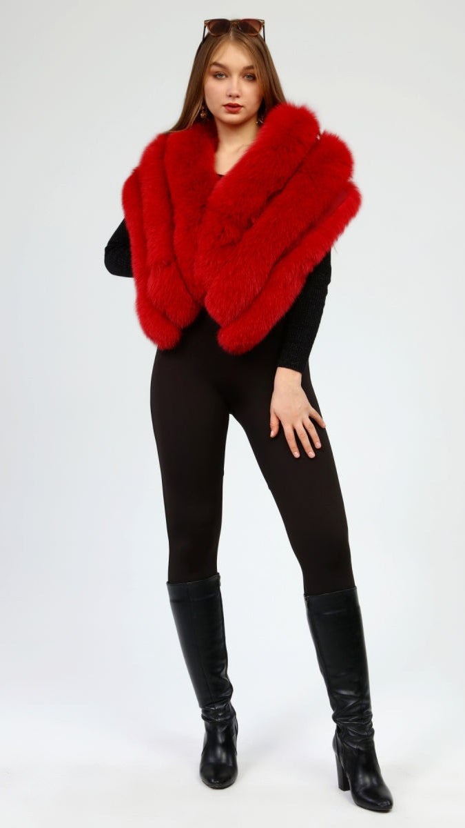 Person wearing a red fox fur shawl and black outfit on a white background