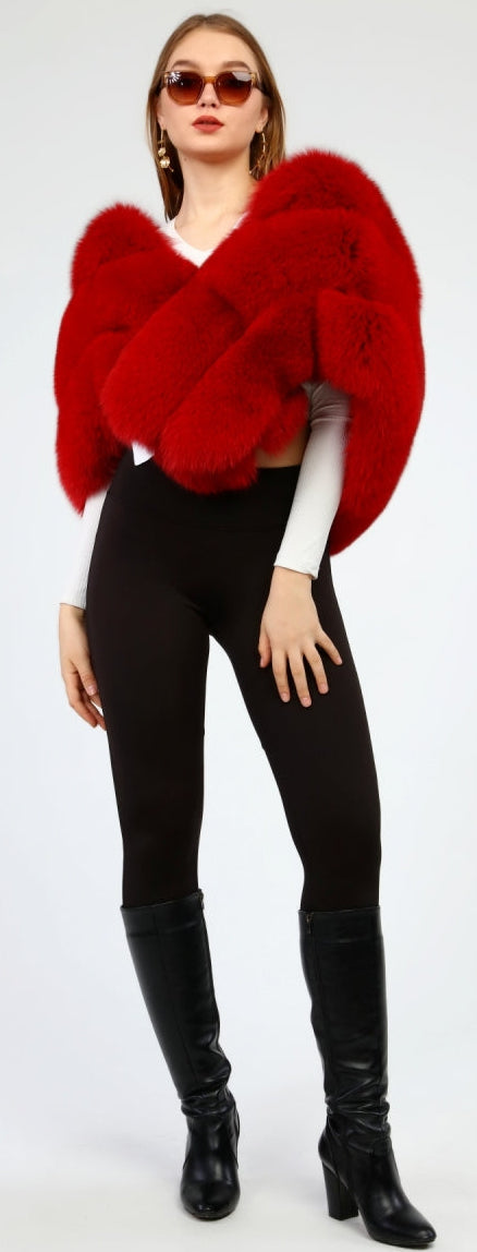 Woman wearing a red fox fur shawl, black leggings, and black boots on a white background