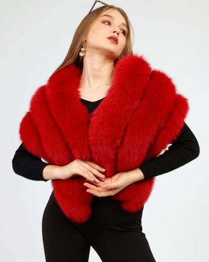 Woman wearing a red fox fur shawl against a white background