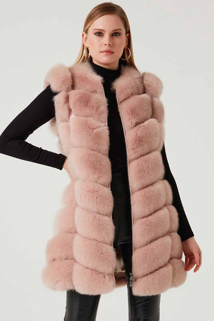 Woman wearing a pink fox fur vest on a white background