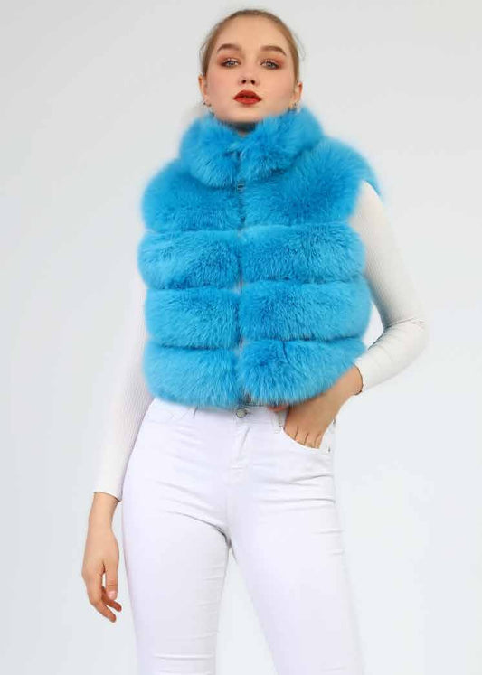 Woman wearing a bright blue fur vest against a white background