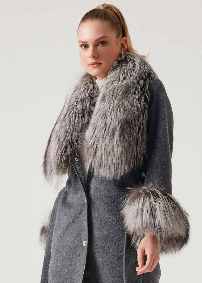 Woman wearing a gray coat with fur trim on a white background