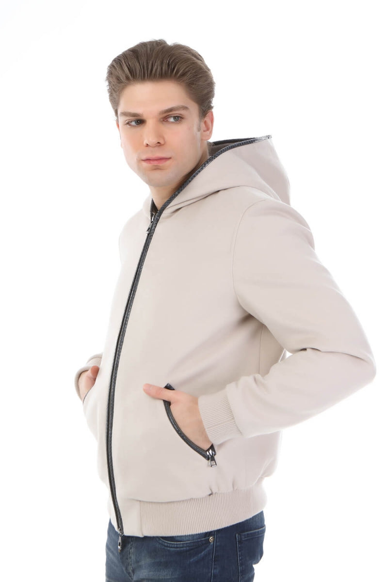Man wearing a beige hoodie with a zipper on a white background