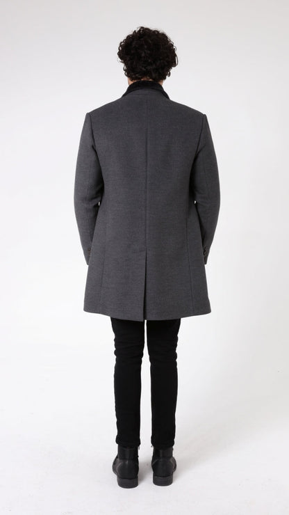 Man wearing a gray coat on a white background